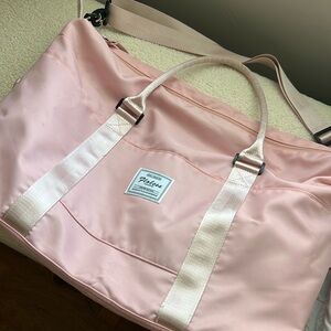 Floless Bags pink nylon travel bag.